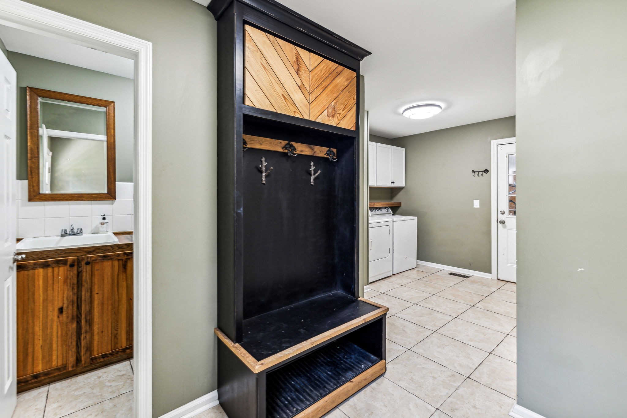 915 Woosley Road Tullahoma, TN 37388 - Photo 27 of 70 Utility Room has new built in coat & shoe cubby, full bath with shower, huge linen closet or third pantry area. This makes it a great mud room area if out working on the farm or shop.
