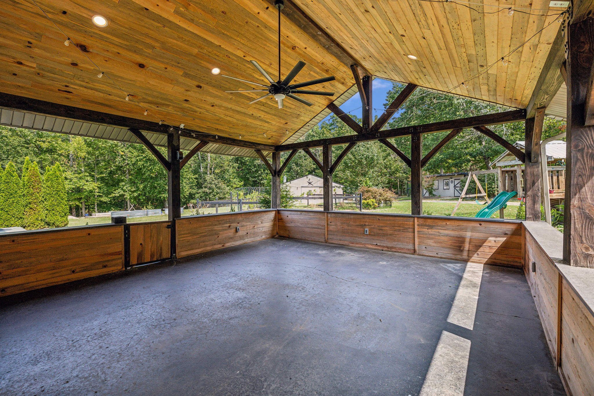 915 Woosley Road Tullahoma, TN 37388 - Photo 60 of 70 Look at this covered back patio. It is huge, partially closed in. Would be easy to screen in but it is just perfect to entertain on.