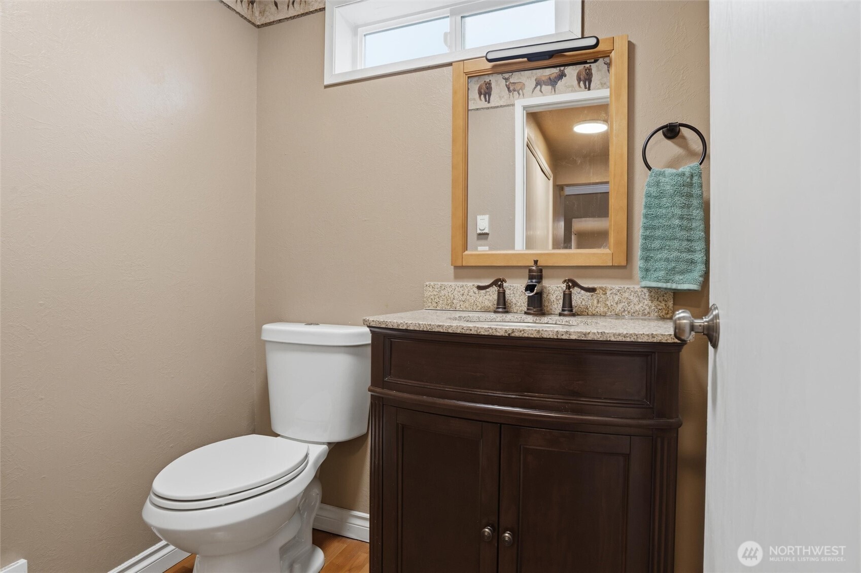 19855 Stavanger Loop Northeast Poulsbo, WA 98370 - Photo 22 of 37 a bathroom with a granite countertop toilet sink and a mirror
