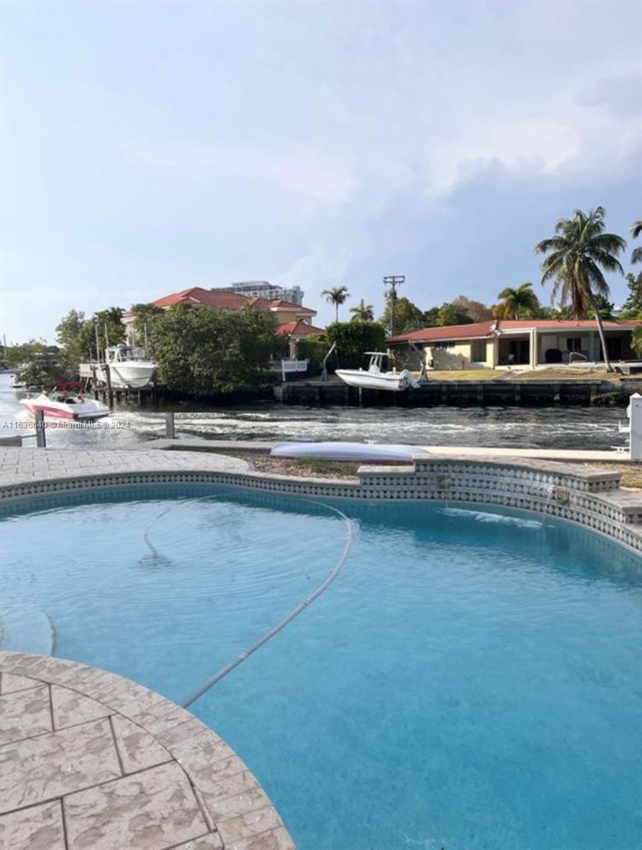 2005 Ixora Road North Miami, FL 33181 - Photo 5 of 15 a view of a swimming pool with an outdoor seating