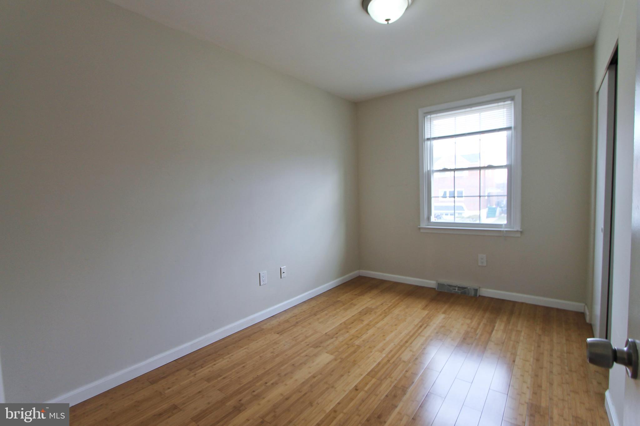 617 Renz Street Philadelphia, PA 19128 - Photo 12 of 28 an empty room with wooden floor and windows