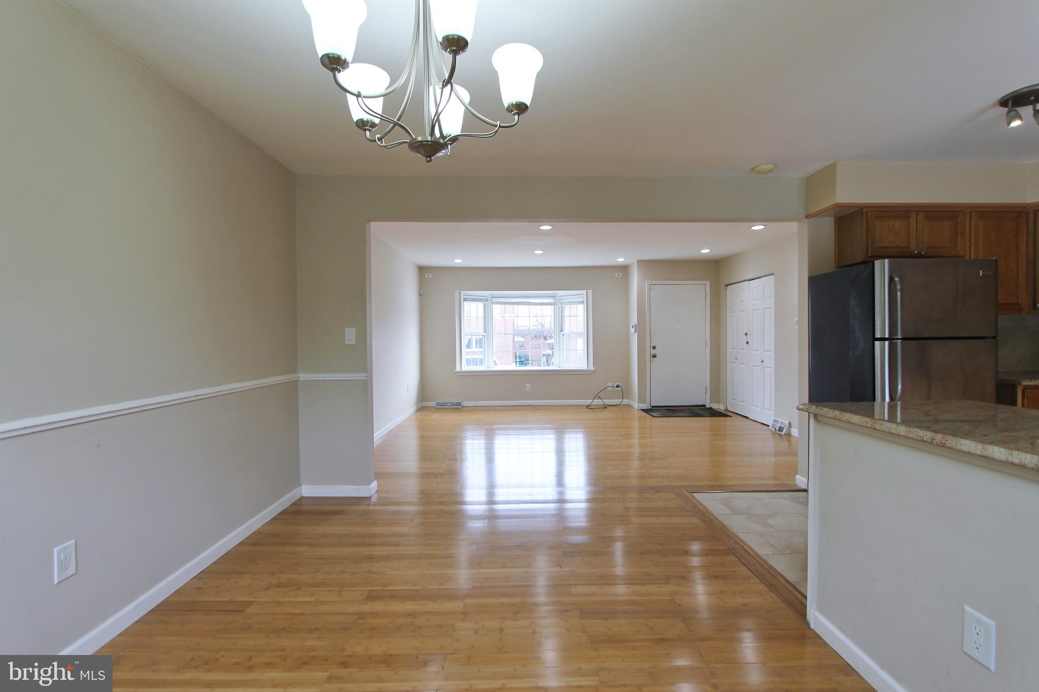 617 Renz Street Philadelphia, PA 19128 - Photo 16 of 28 a view of a hallway with wooden floor and a kitchen
