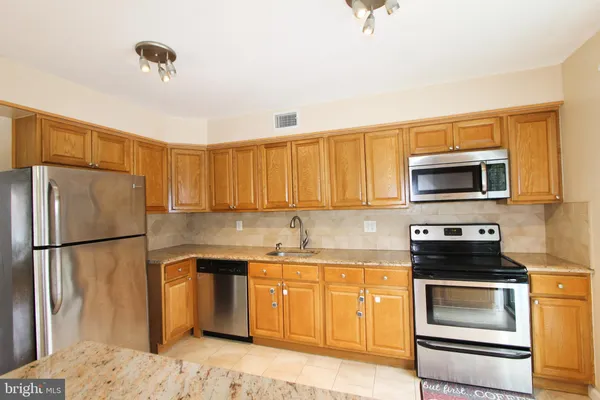 a kitchen with a refrigerator stove and microwave