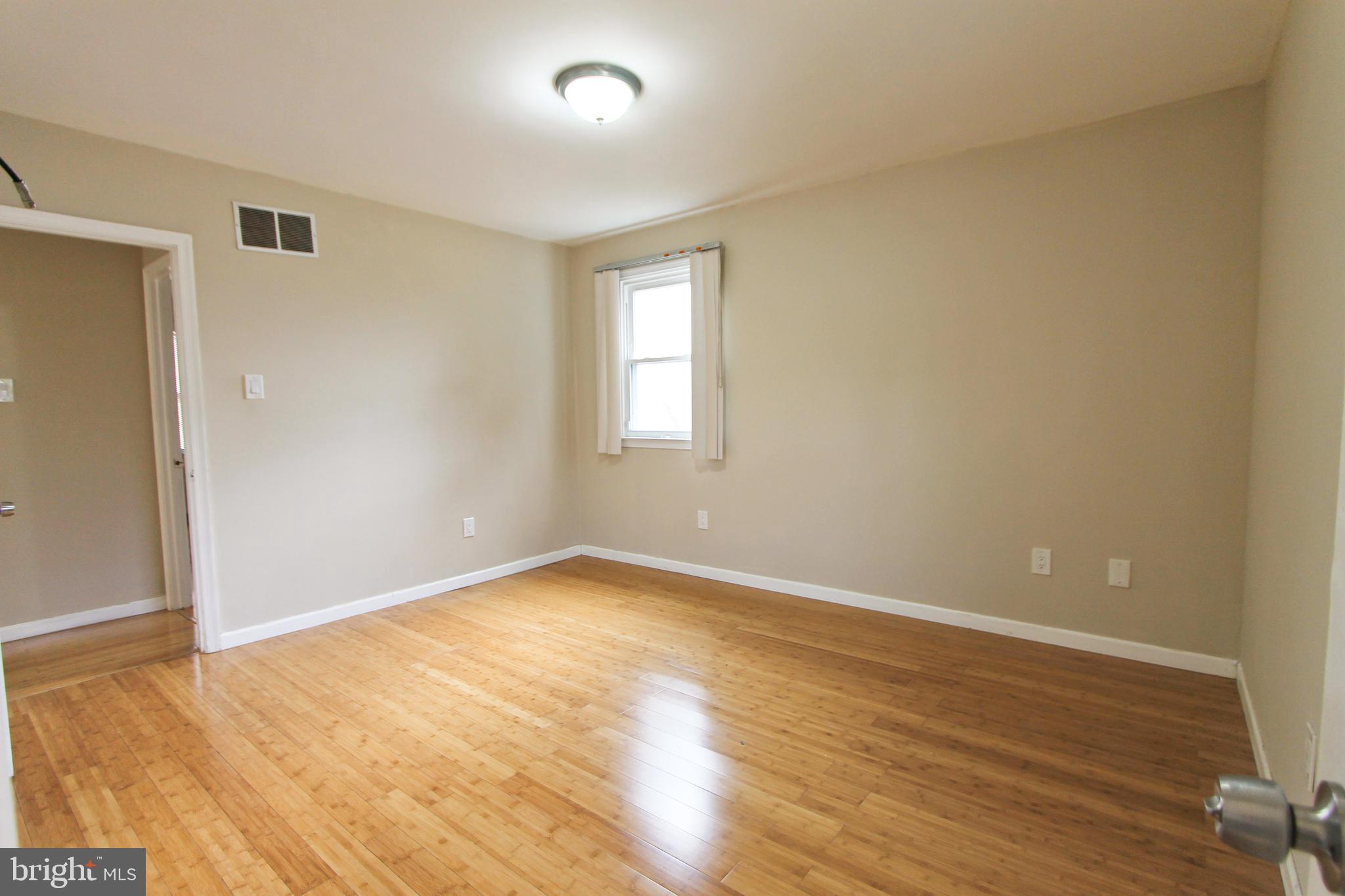 617 Renz Street Philadelphia, PA 19128 - Photo 26 of 28 an empty room with wooden floor and windows