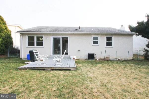 a view of a house with backyard and chairs