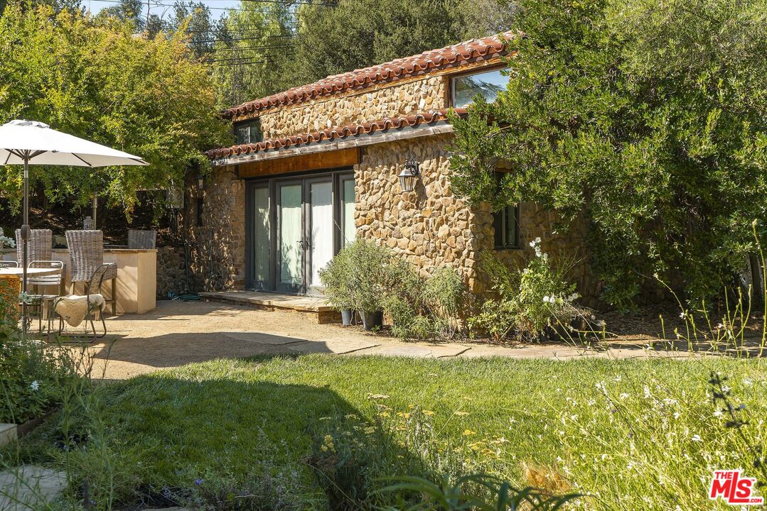 2251 Cold Canyon Road Calabasas, CA 91302 - Photo 39 of 47 a view of a house with a yard