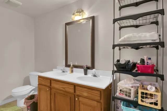 a bathroom with a toilet sink and mirror