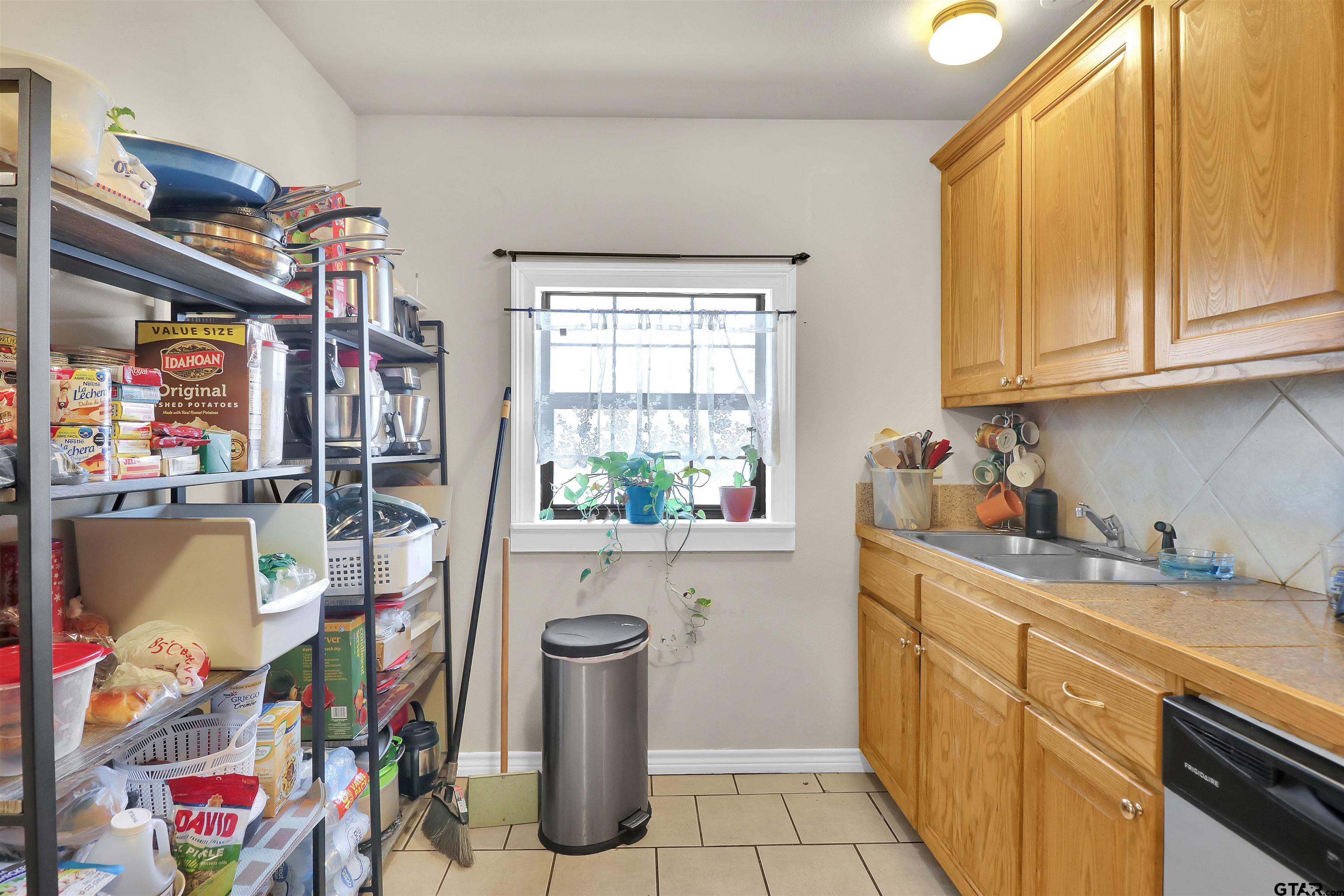 1224 West 3rd Street Tyler, TX 75701 - Photo 5 of 14 a view of a kitchen with appliances and cabinets