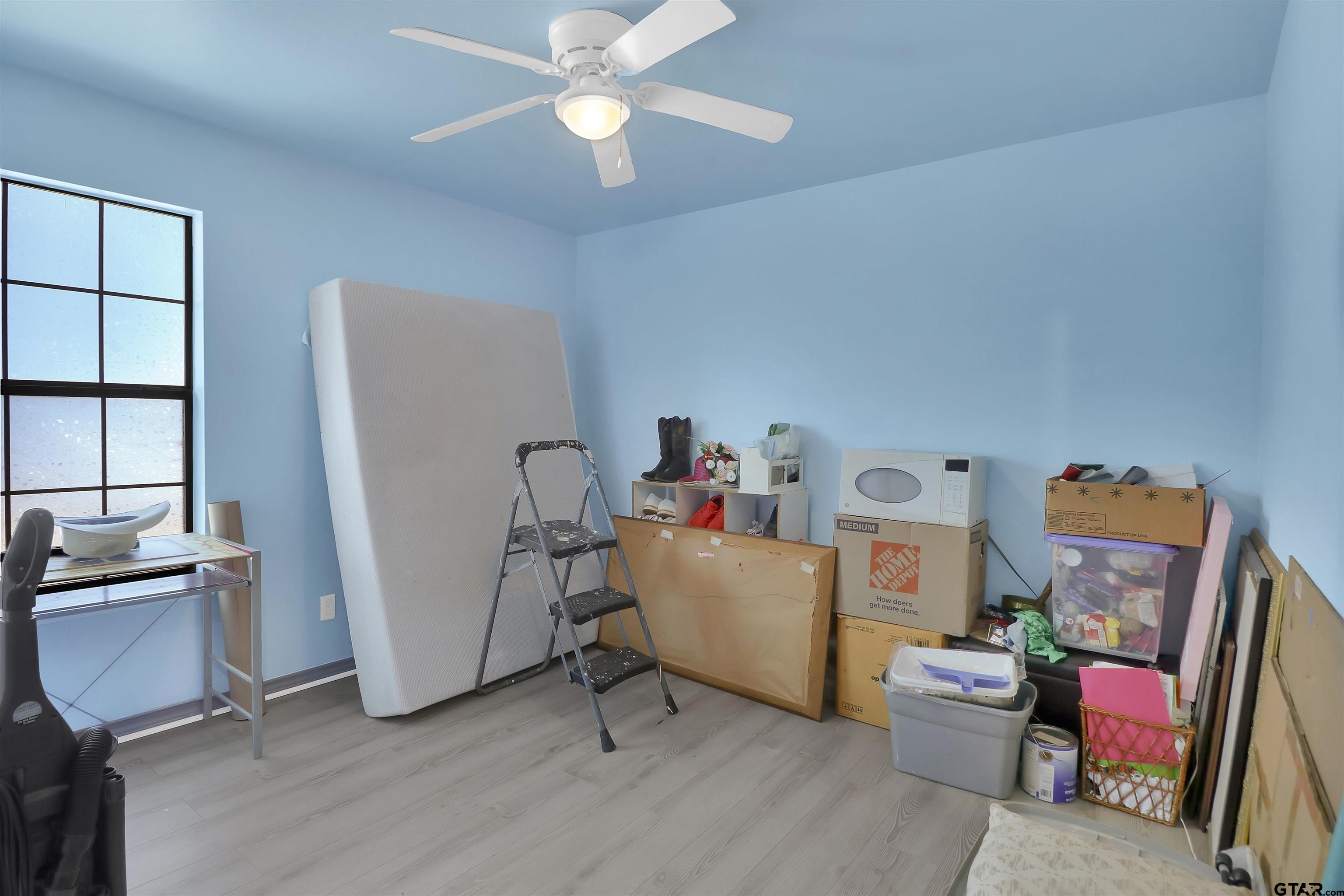 1224 West 3rd Street Tyler, TX 75701 - Photo 8 of 14 a living room with furniture and a flat screen tv