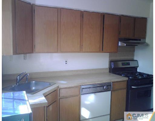 63 Redbud Road Piscataway, NJ 08854 - Photo 2 of 6 a kitchen with a sink cabinets and stove top oven