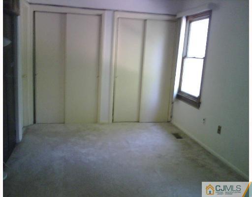 63 Redbud Road Piscataway, NJ 08854 - Photo 3 of 6 a view of an empty room with a window