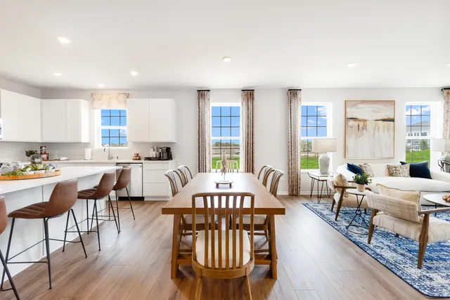 a view of a a dining room with furniture window and wooden floor