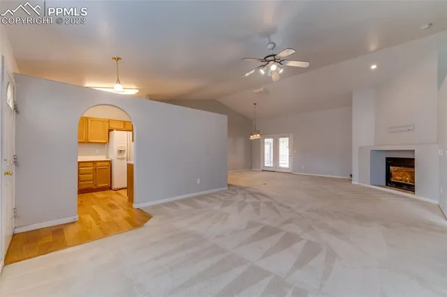 a view of a bedroom with window and ceiling fan