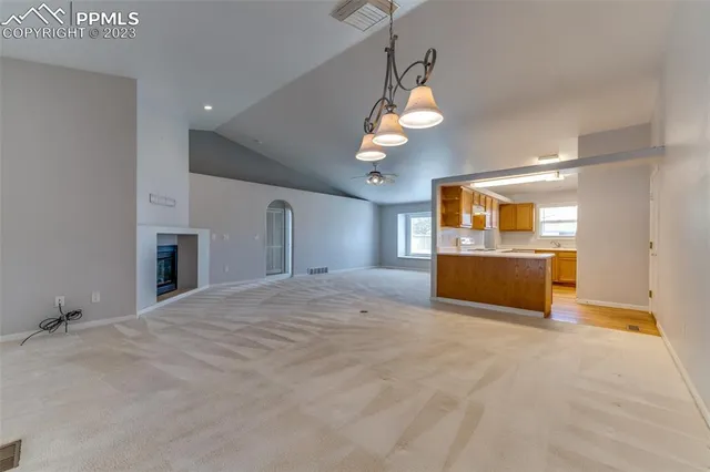 a kitchen with stainless steel appliances granite countertop a sink a stove top oven a counter space and cabinets