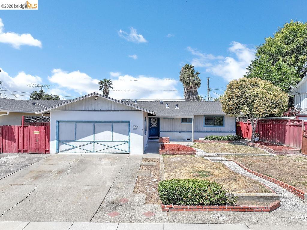 805 Calero Street Milpitas, CA 95035 - Photo 2 of 23 Single-story residence featuring an attached garage with a decorative door, a driveway, and a front yard with brick-lined planters