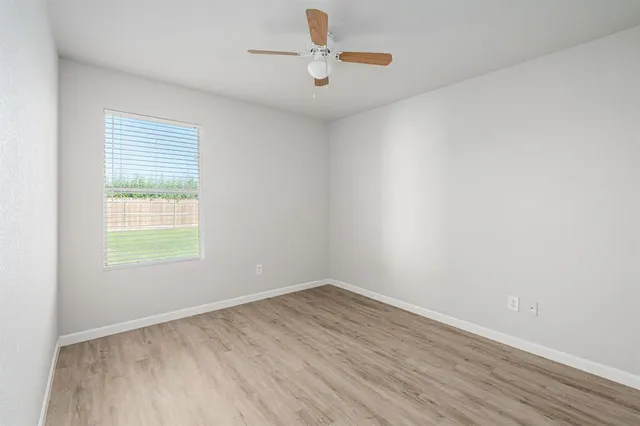 wooden floor in an empty room with a window