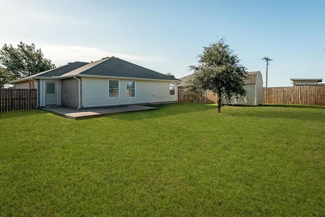 a big house with a big yard and large trees