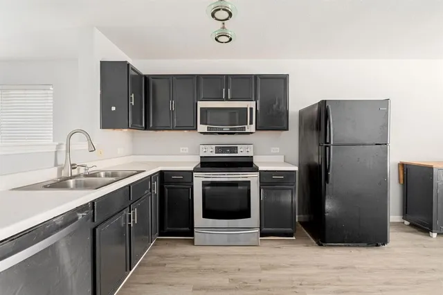 a kitchen with a refrigerator sink and microwave