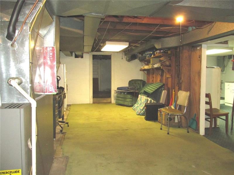380 Dillon Road Acme, PA 15610 - Photo 19 of 25 Other side To the left is the furnace. There are 2 oil tanks stored behind the photographer. Through the open door is the laundry room.