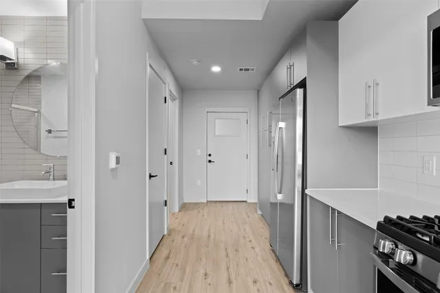 a view of a hallway with wooden floor