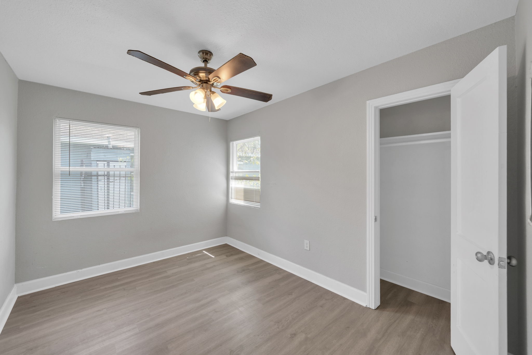 12358 Mylla Street Houston, TX 77015 - Photo 11 of 17 a view of a room with wooden floor and a ceiling fan
