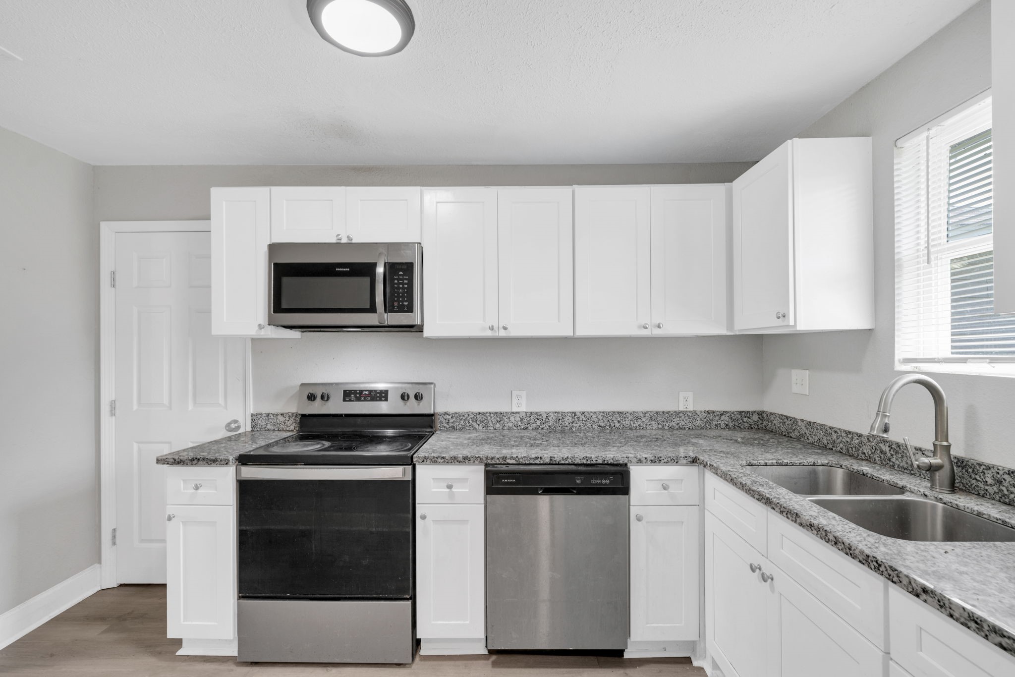 12358 Mylla Street Houston, TX 77015 - Photo 3 of 17 a kitchen with white cabinets stainless steel appliances and sink