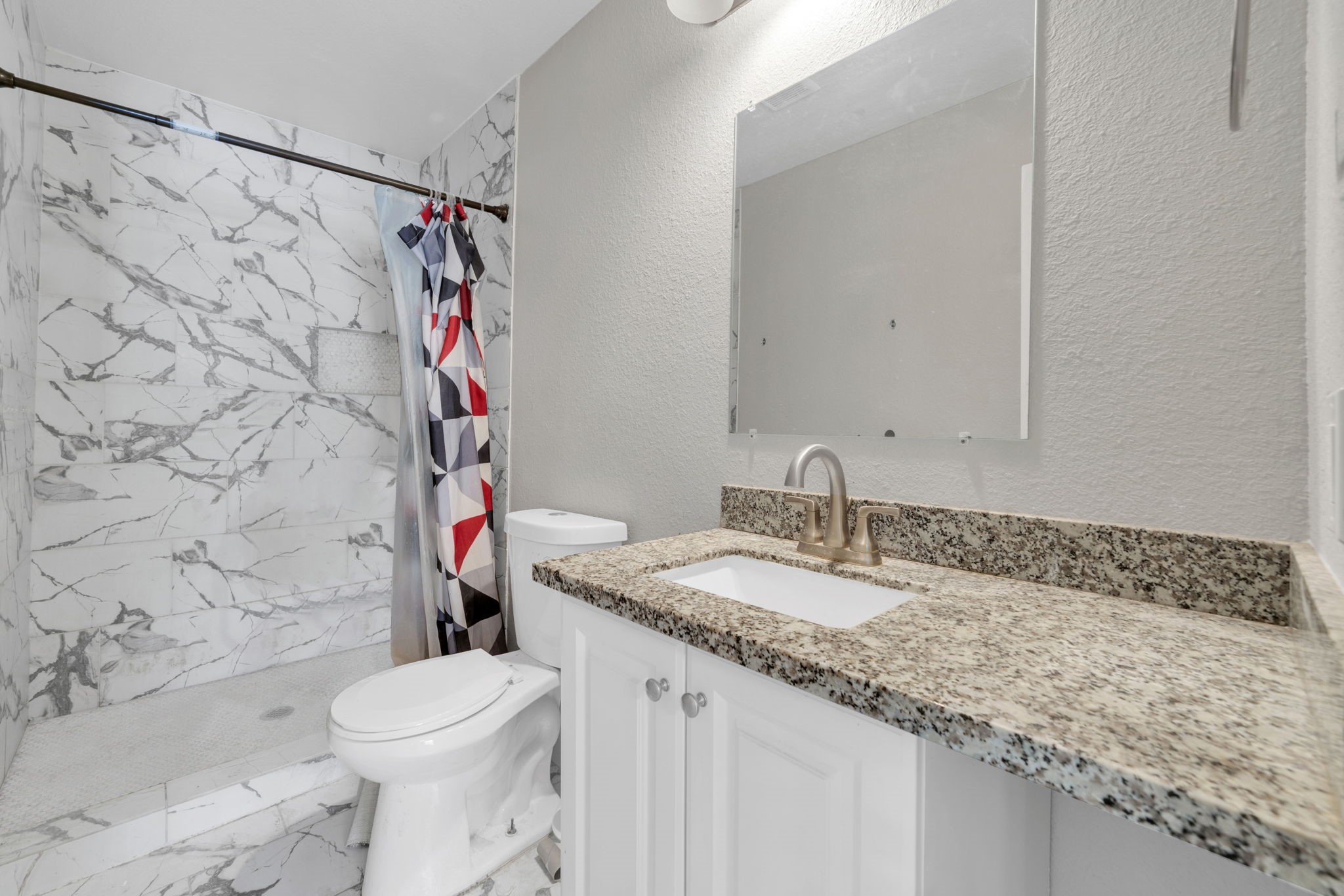 12358 Mylla Street Houston, TX 77015 - Photo 8 of 17 a bathroom with a granite countertop sink and a mirror