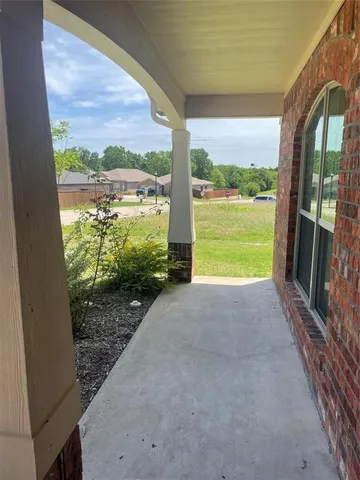 a view of a glass door with a yard from a balcony