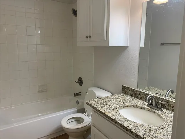 a view of an empty room with a chandelier fan