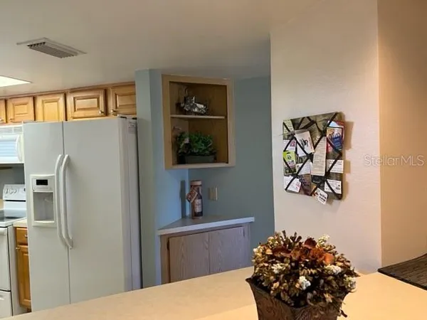 a kitchen with stainless steel appliances a refrigerator and a stove