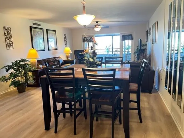 a view of a dining room with furniture and wooden floor