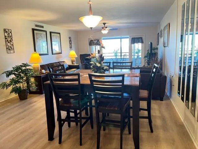 a view of a dining room with furniture and wooden floor