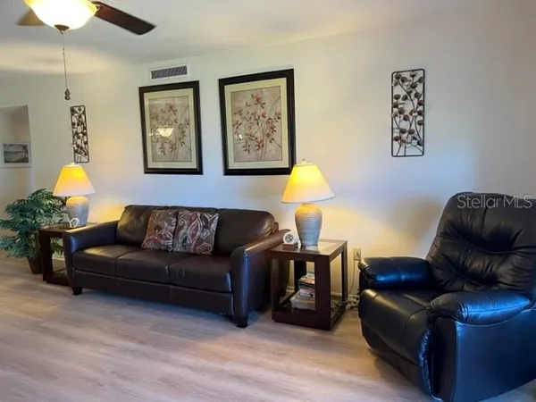 a living room with furniture a lamp and a window