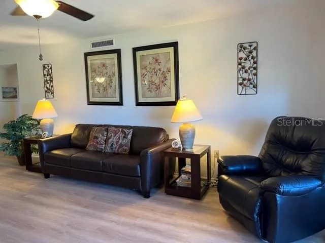 a living room with furniture a lamp and a window