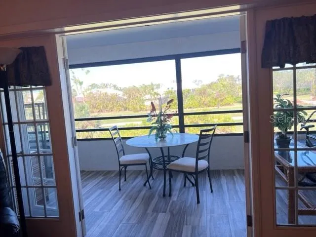 a view of a city from a dining room with a table and chairs