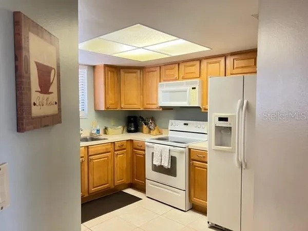 a kitchen with a white cabinets and white appliances