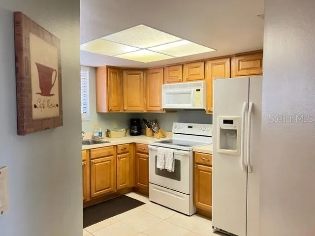 a kitchen with a white cabinets and white appliances