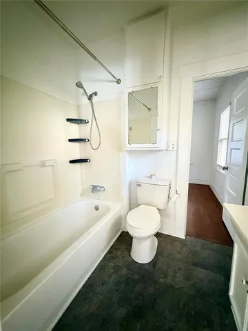 a bathroom with a bathtub and a toilet