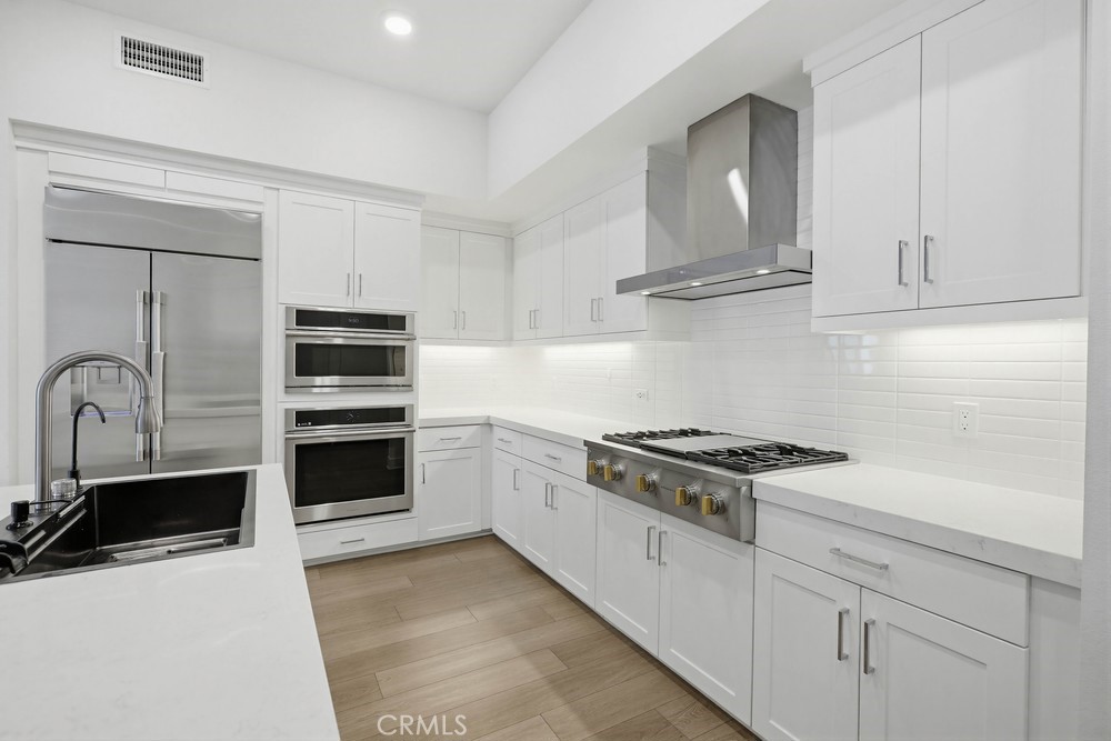 1604 Rivington Irvine, CA 92612 - Photo 21 of 75 a kitchen with stainless steel appliances granite countertop a sink stove and refrigerator