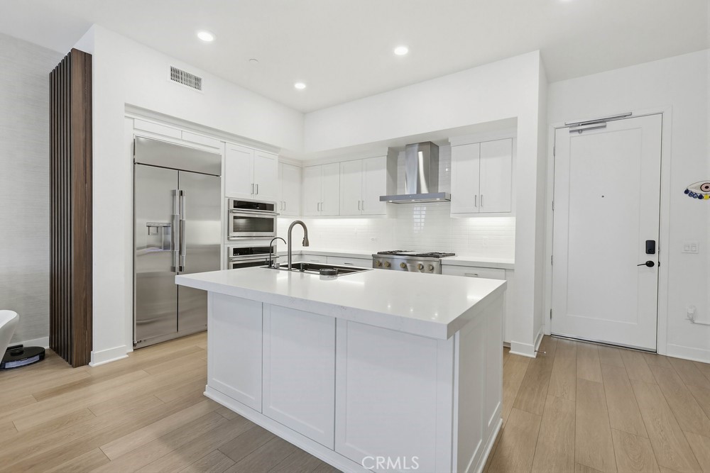 1604 Rivington Irvine, CA 92612 - Photo 22 of 75 a kitchen with kitchen island a sink stainless steel appliances and cabinets