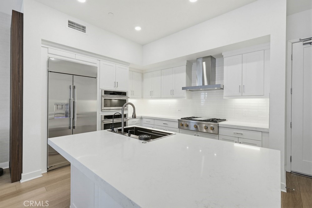 1604 Rivington Irvine, CA 92612 - Photo 23 of 75 a kitchen with stainless steel appliances a stove a sink and a refrigerator