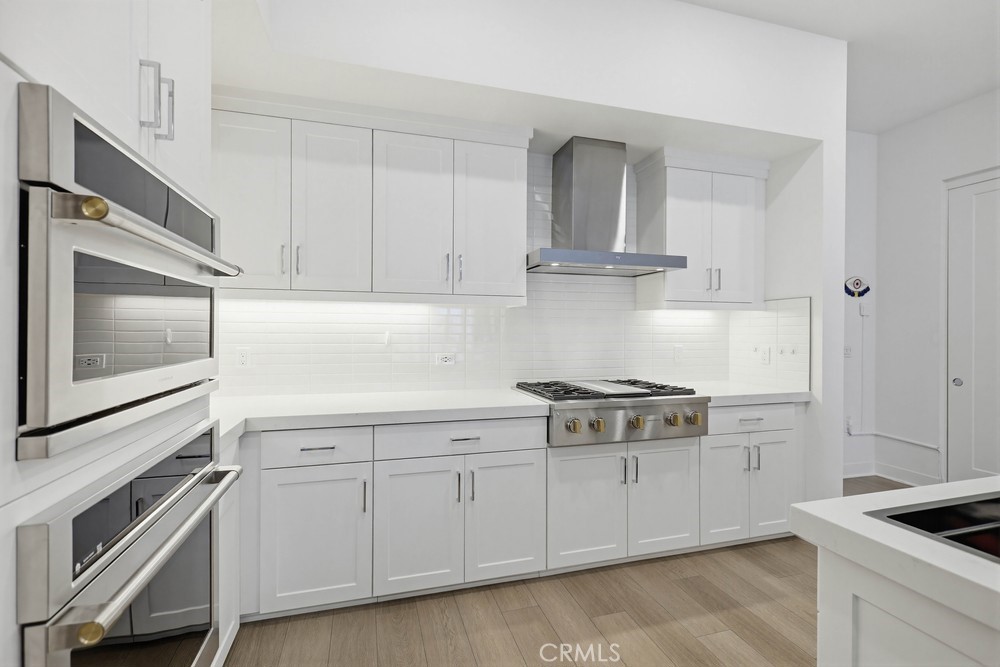 1604 Rivington Irvine, CA 92612 - Photo 25 of 75 a kitchen with white cabinets and appliances