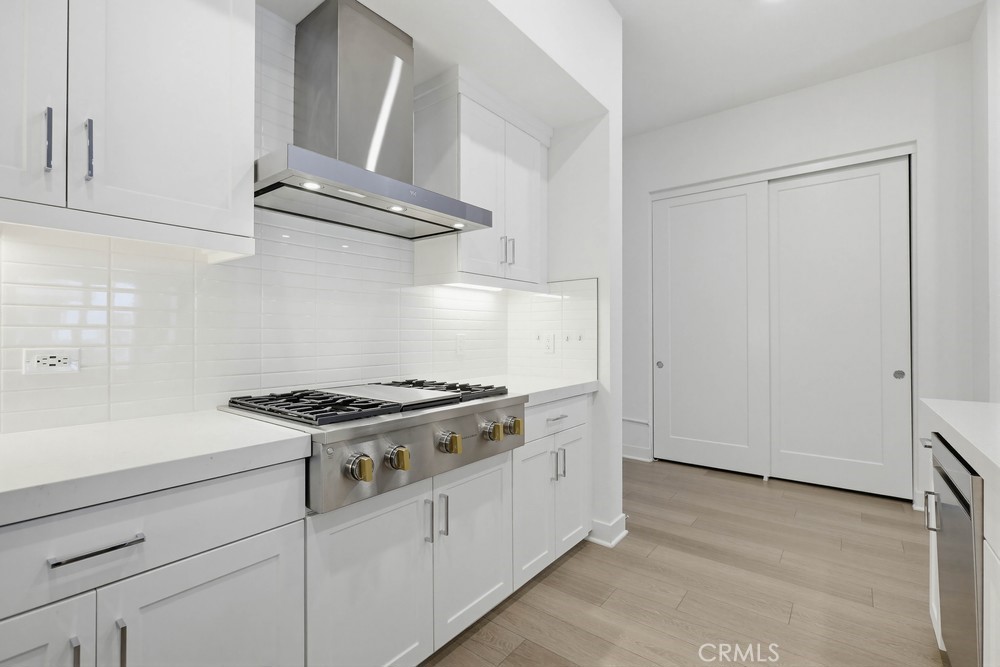 1604 Rivington Irvine, CA 92612 - Photo 27 of 75 a kitchen with granite countertop white cabinets and white appliances