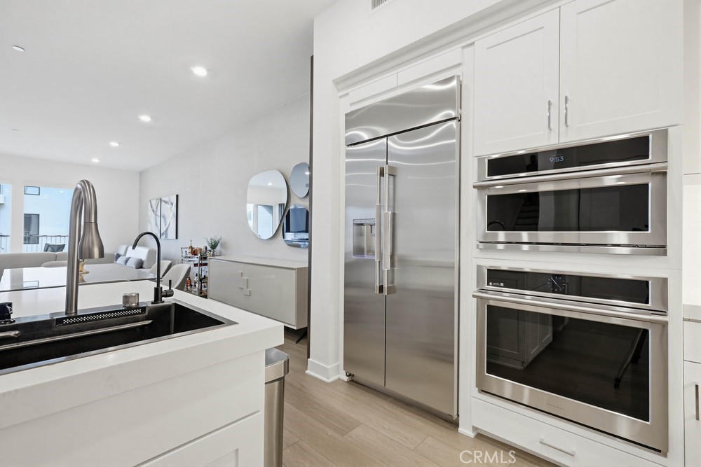 1604 Rivington Irvine, CA 92612 - Photo 28 of 75 a kitchen with granite countertop a sink stove and refrigerator