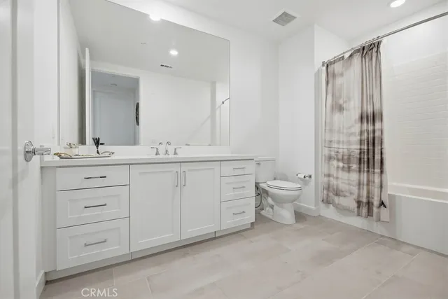 a bedroom with a bed and a mirror