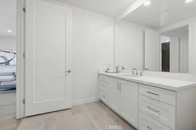 a bathroom with a double vanity sink mirror and shower