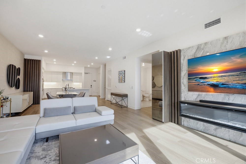 1604 Rivington Irvine, CA 92612 - Photo 3 of 75 a living room with stainless steel appliances furniture and a flat screen tv