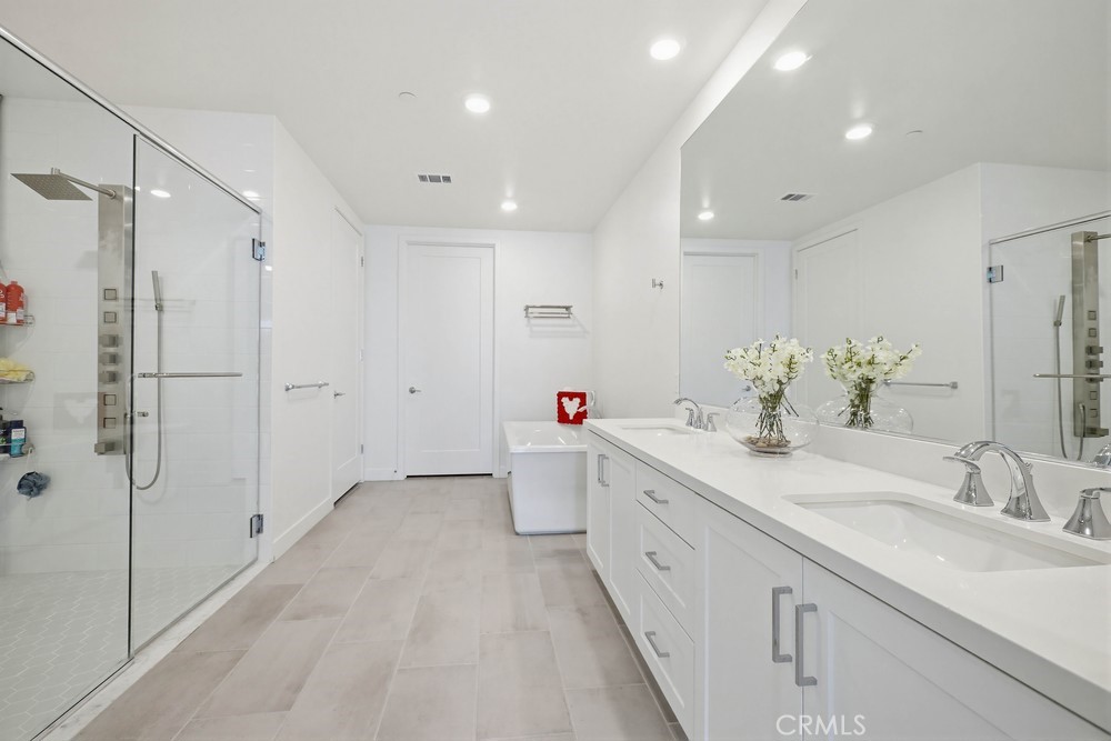 1604 Rivington Irvine, CA 92612 - Photo 38 of 75 a bathroom with a double vanity sink mirror and shower