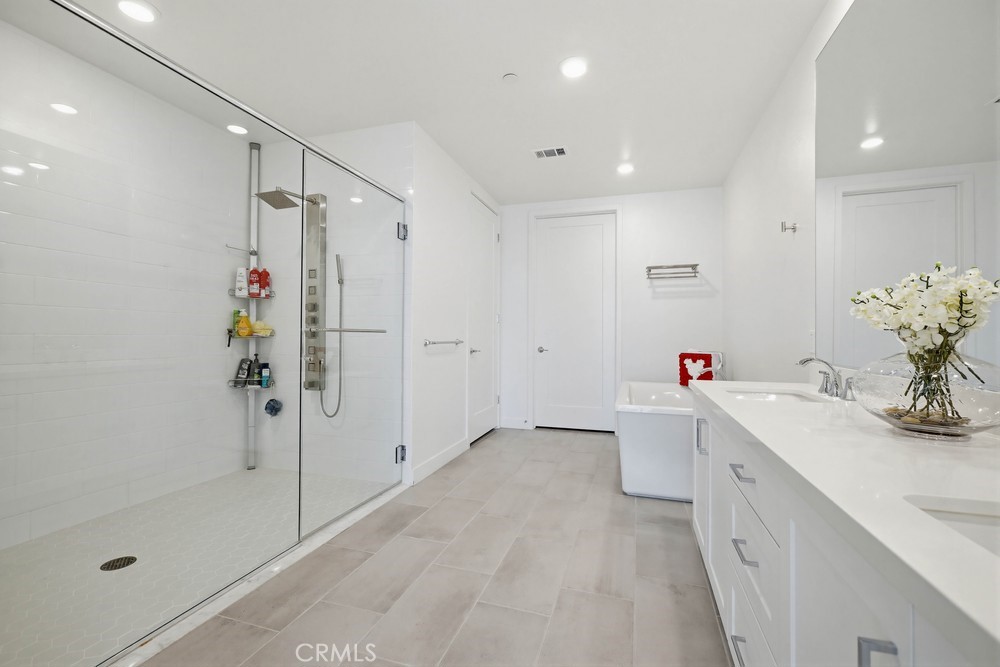 1604 Rivington Irvine, CA 92612 - Photo 39 of 75 a bathroom with a sink mirror and shower