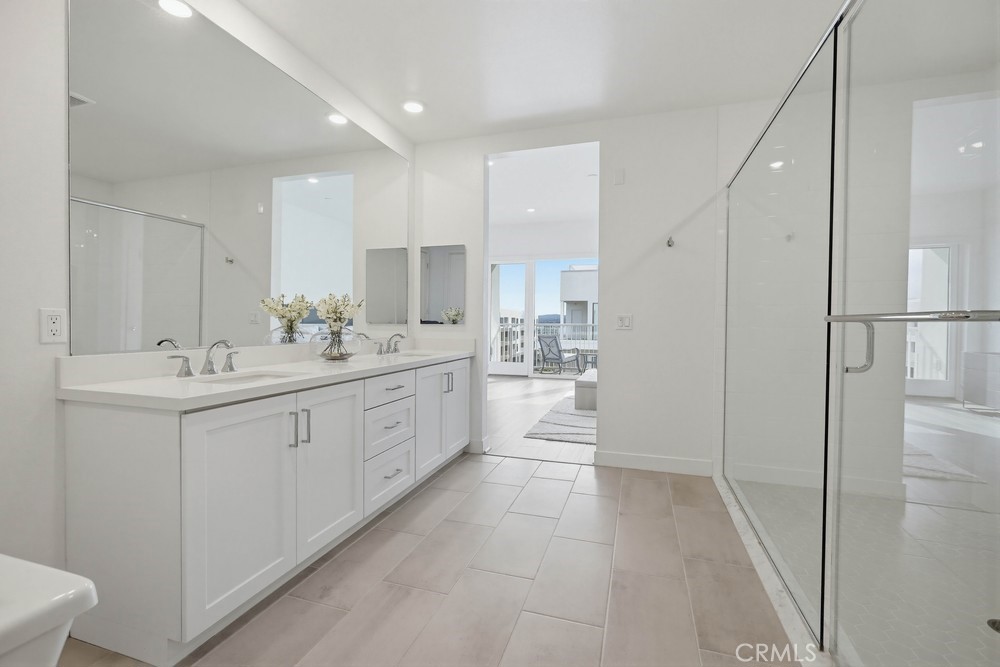 1604 Rivington Irvine, CA 92612 - Photo 42 of 75 a large white kitchen with a sink a window and stainless steel appliances